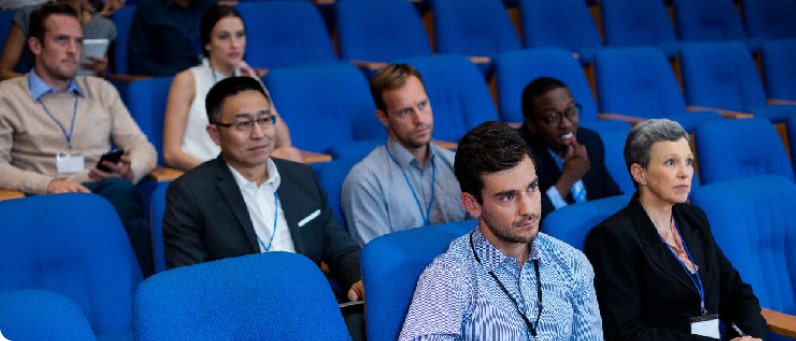 Personas sentadas en un auditorio mirando hacía el frente